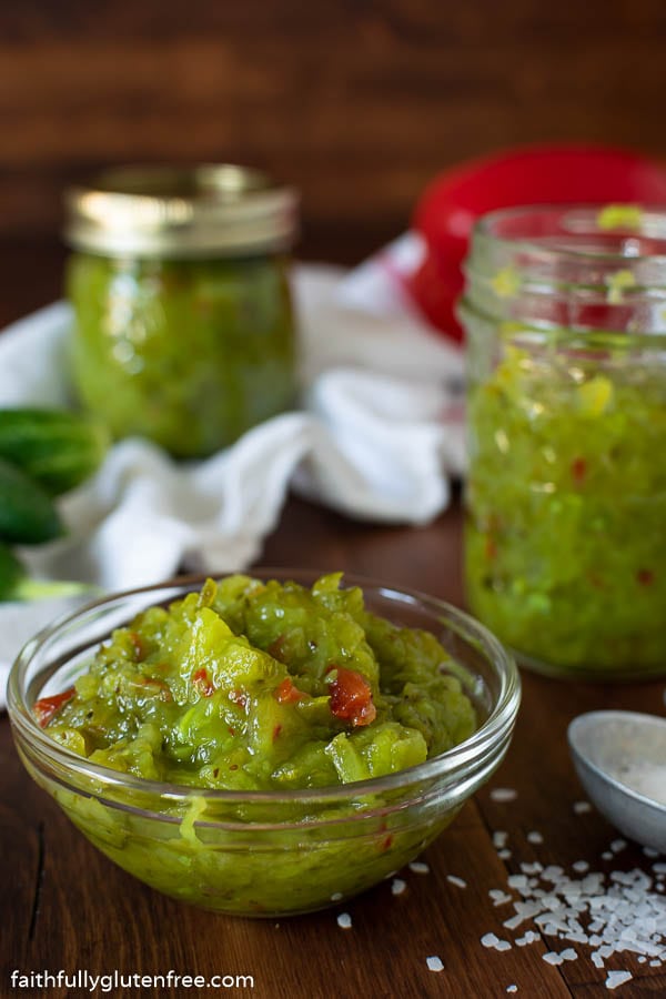 A bowl and canning jars of homemade relish