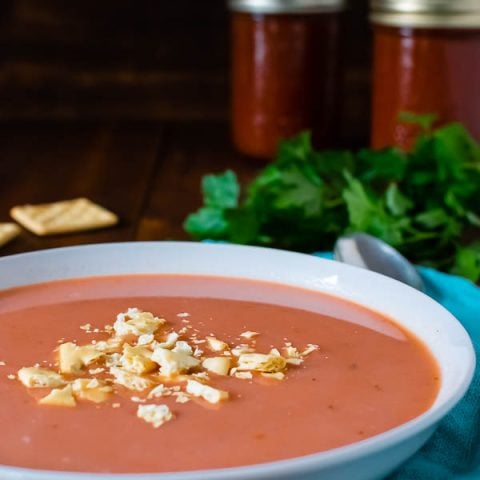 Bowl of homemade tomato soup topped with crackers