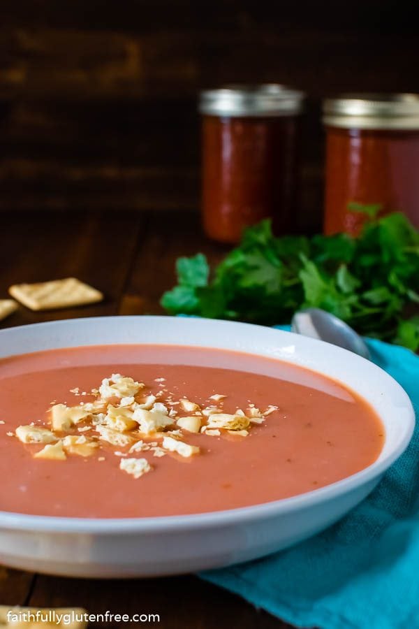 Bowl of homemade tomato soup topped with crackers