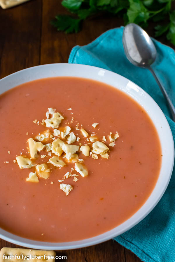 Bowl of tomato soup topped with crushed crackers