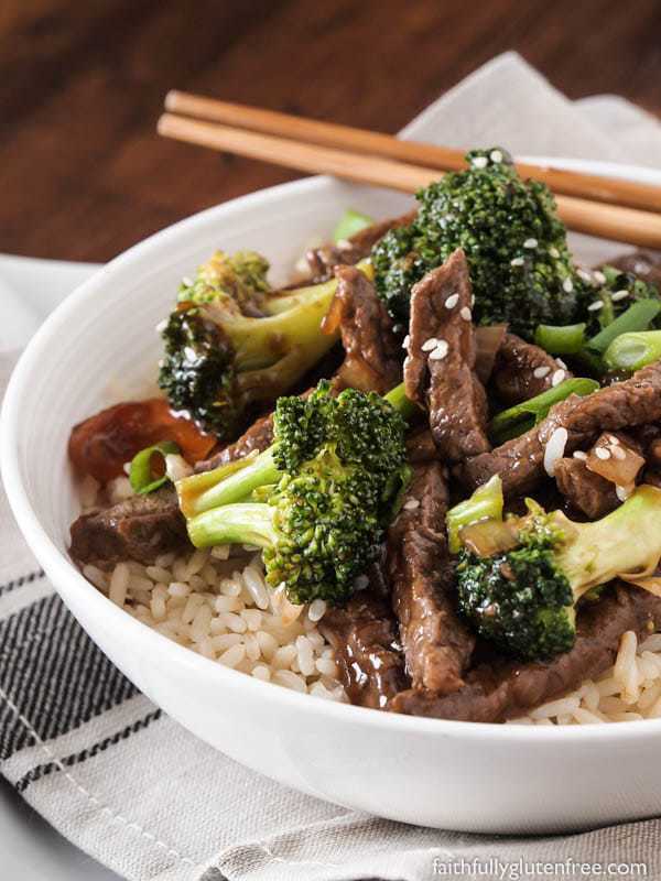 A bowl of rice topped with beef and broccoli stir fry