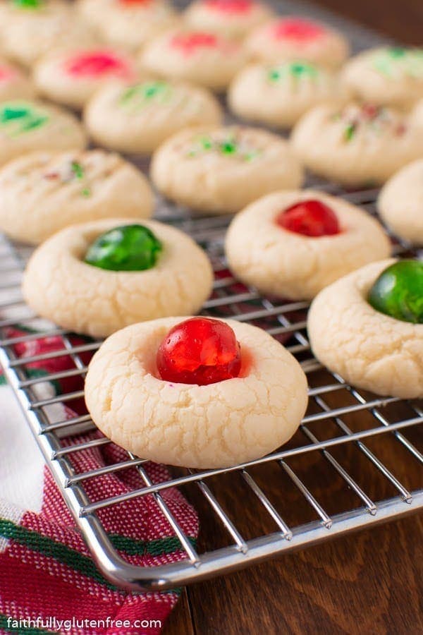 A tray of whipped shortbread cookies with cherries