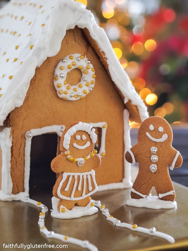 Gluten Free Gingerbread House with a couple standing outside