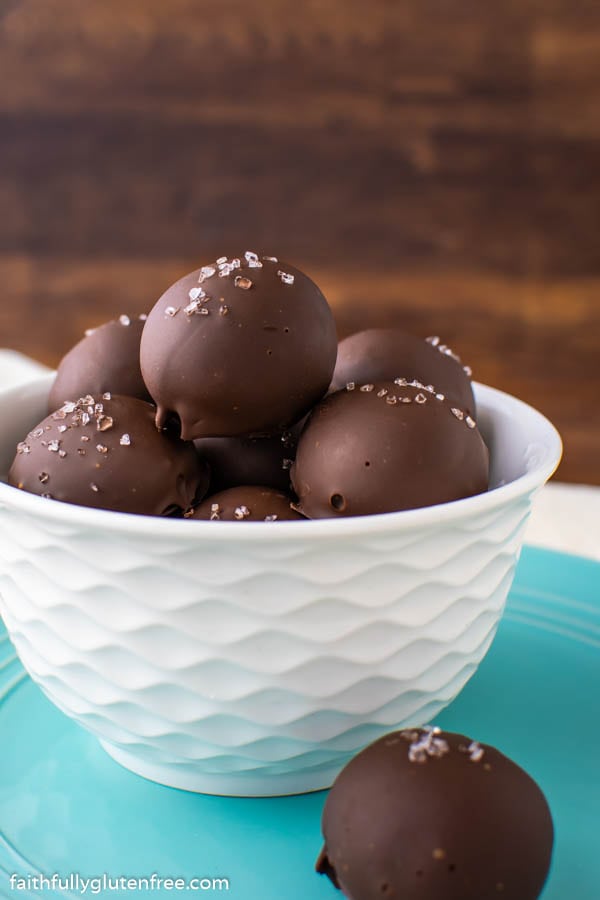a white bowl of chocolate truffles