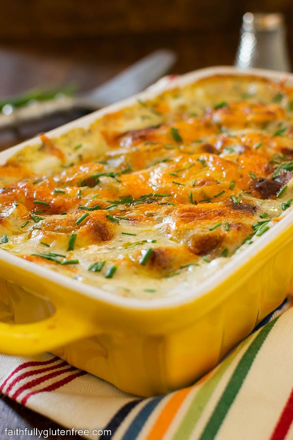 a casserole of scalloped potatoes covered in browned cheddar cheese
