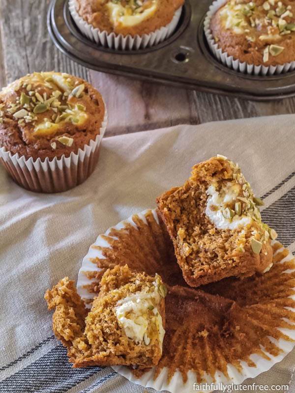 A few gluten free pumpkin cream cheese muffins broken apart, and ready to eat