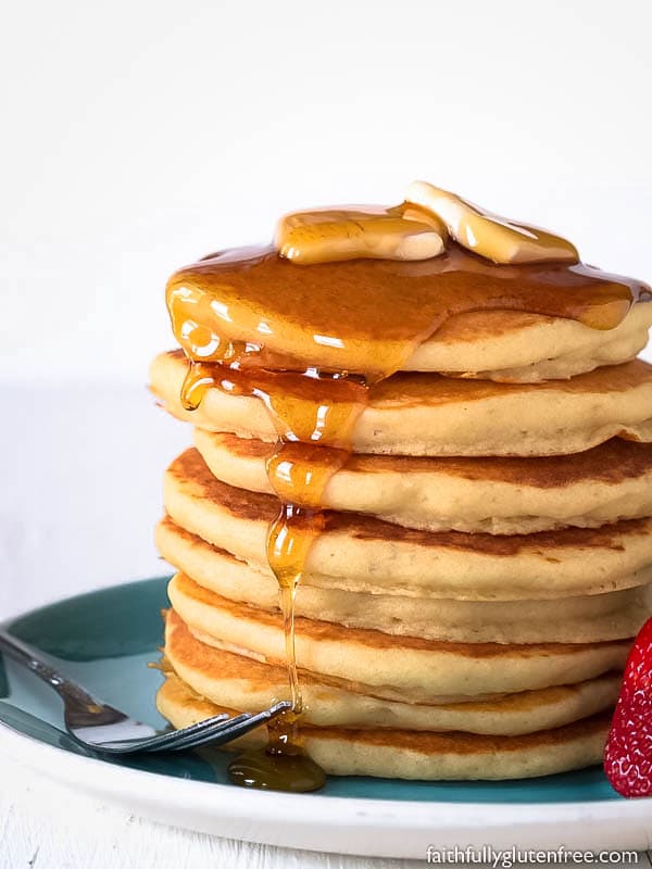 A stack of pancakes drizzled with syrup