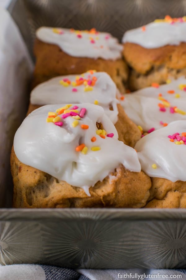 These gluten free Peppernut Buns, also called Papante or Spice Buns, are sweet yeast buns with warming spices, including black pepper. Topped with a simple icing, and sprinkles, they are a traditional Mennonite Easter bun.