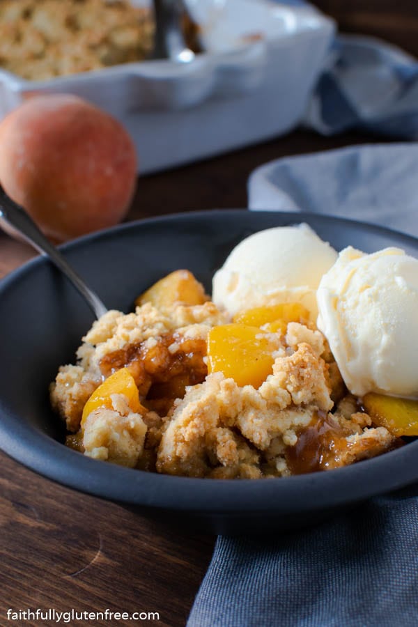 a bowl of peach cobbler with ice cream