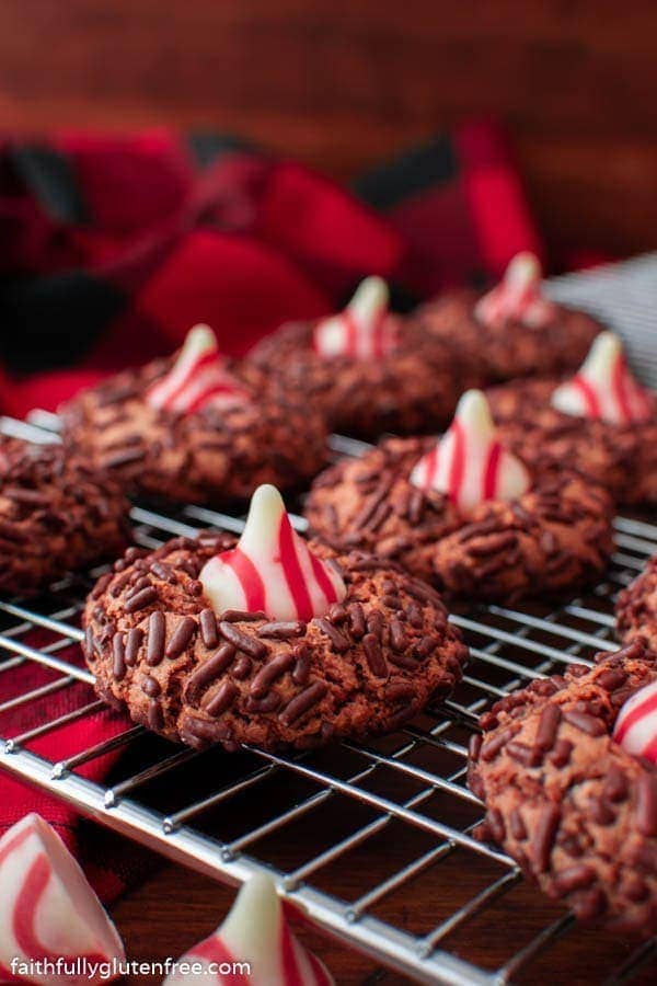 a cooling rack with chocolate candy cane kiss cookies