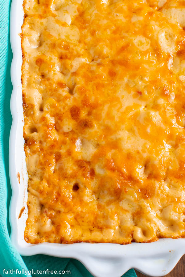 a white baking dish with a casserole topped with melted cheese