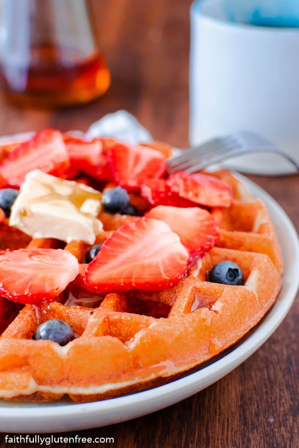 a waffle topped with strawberries and blueberries