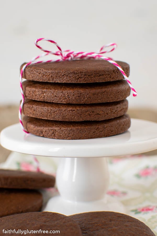 a stack of chocolate sugar cookies on a pedestal 